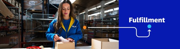 Woman packing parcel in fulfillment